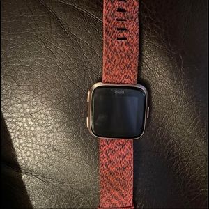Rose gold Fitbit Versa. Comes with original black band and two others.